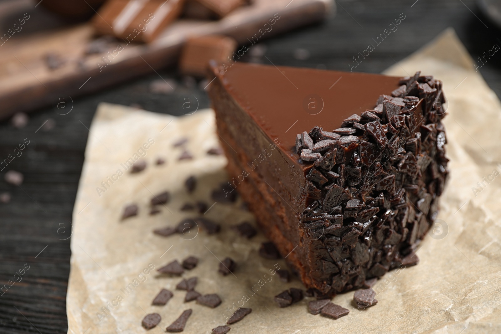 Photo of Delicious fresh chocolate cake on wooden table, closeup