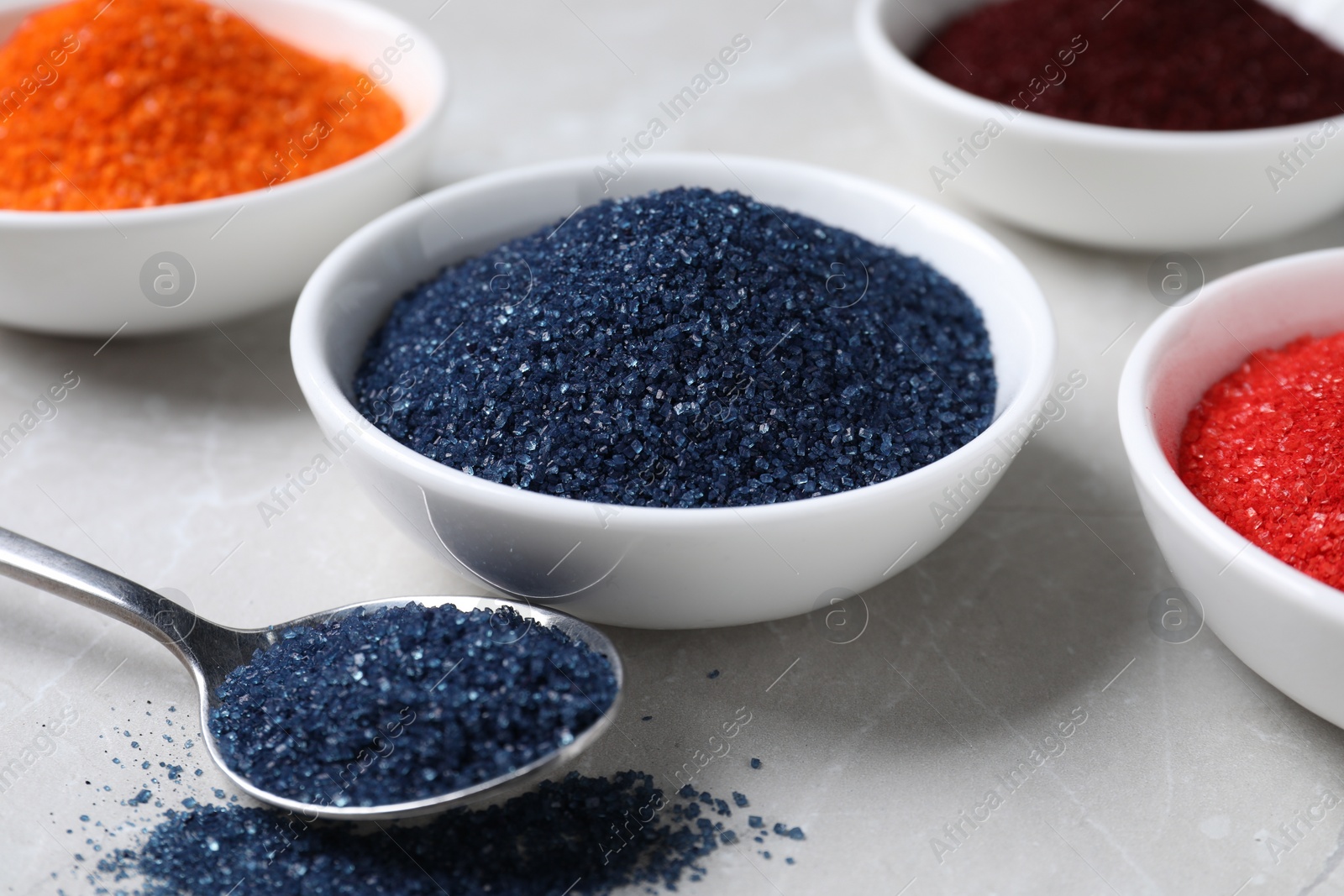 Photo of Many different food coloring on light grey table, closeup