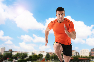 Image of Athletic young man running on sunny day, space for text 