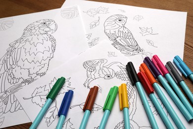Photo of Drawings for coloring and felt tip pens on table