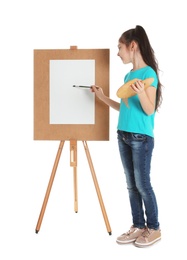 Photo of Child painting picture on easel against white background. Space for text