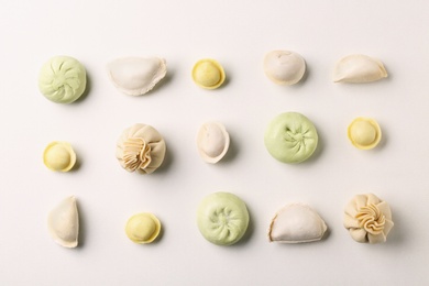 Photo of Composition with different dumplings on white background, top view