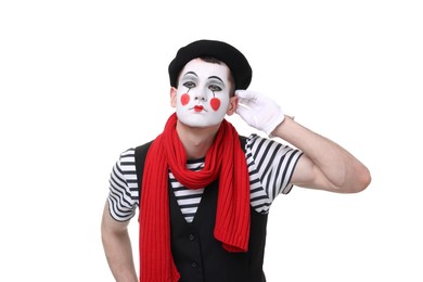 Mime artist showing hand to ear gesture on white background