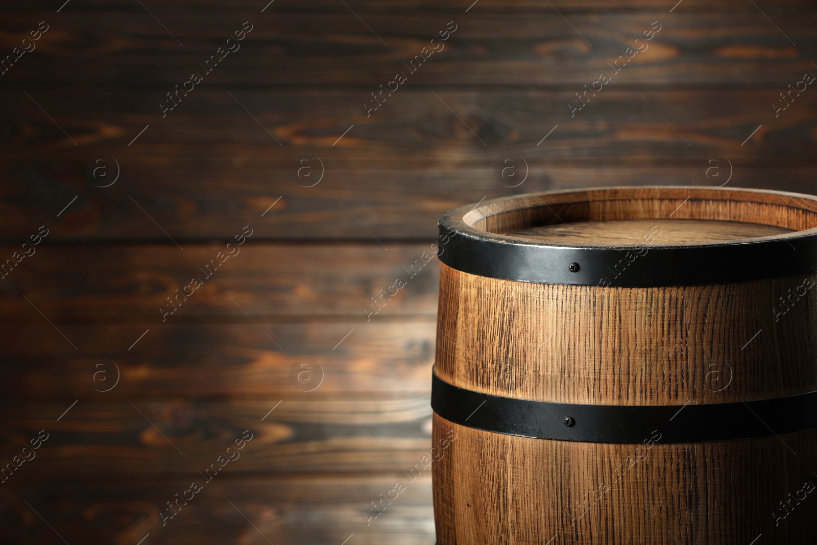 Photo of One wooden barrel near wall, closeup. Space for text