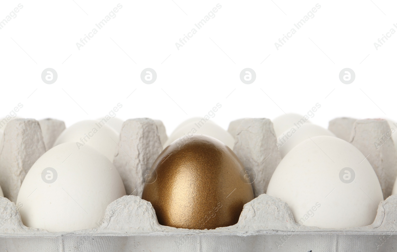 Photo of Egg carton with golden egg among ordinary ones on white background