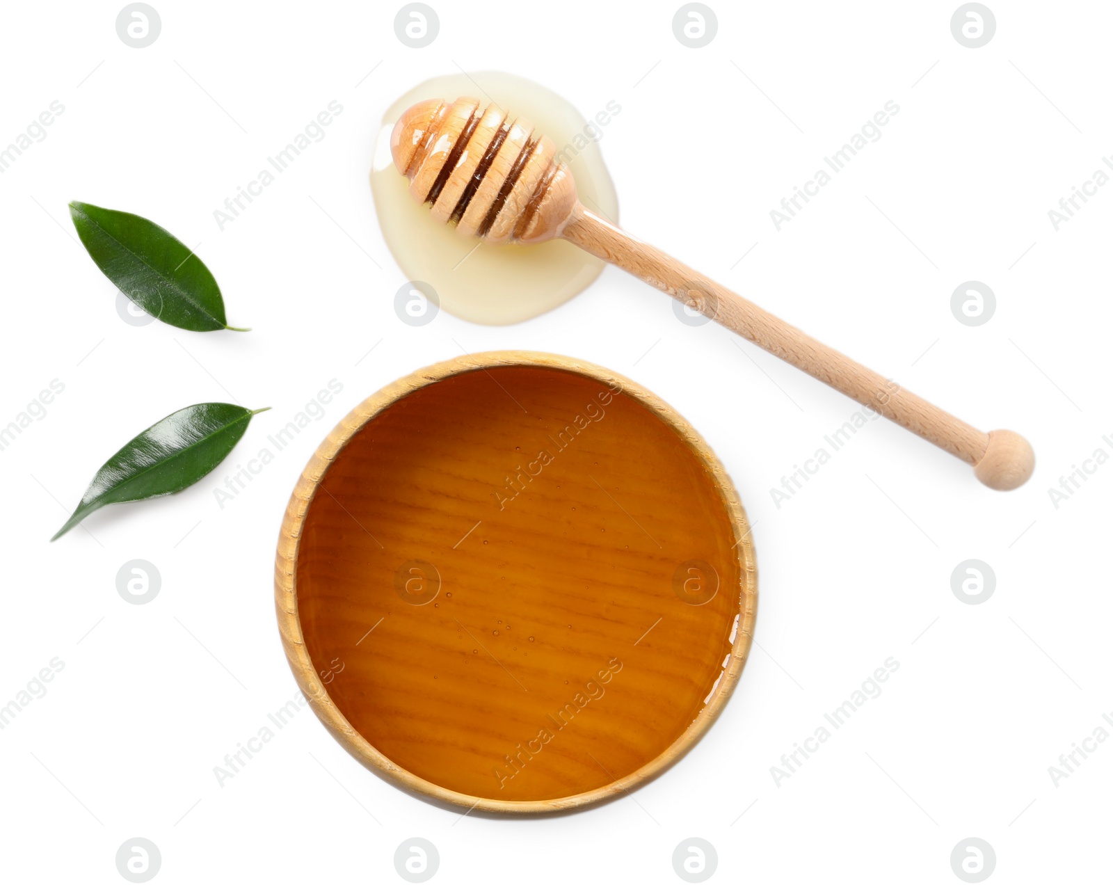 Photo of Tasty honey in bowl, dipper and green leaves on white background, flat lay