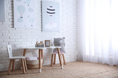 Baby room interior with toys and stylish furniture