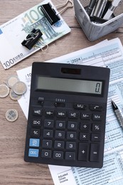 Photo of Tax accounting. Flat lay composition with calculator and document on wooden table