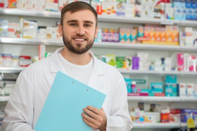 Photo of Professional pharmacist with clipboard in modern drugstore