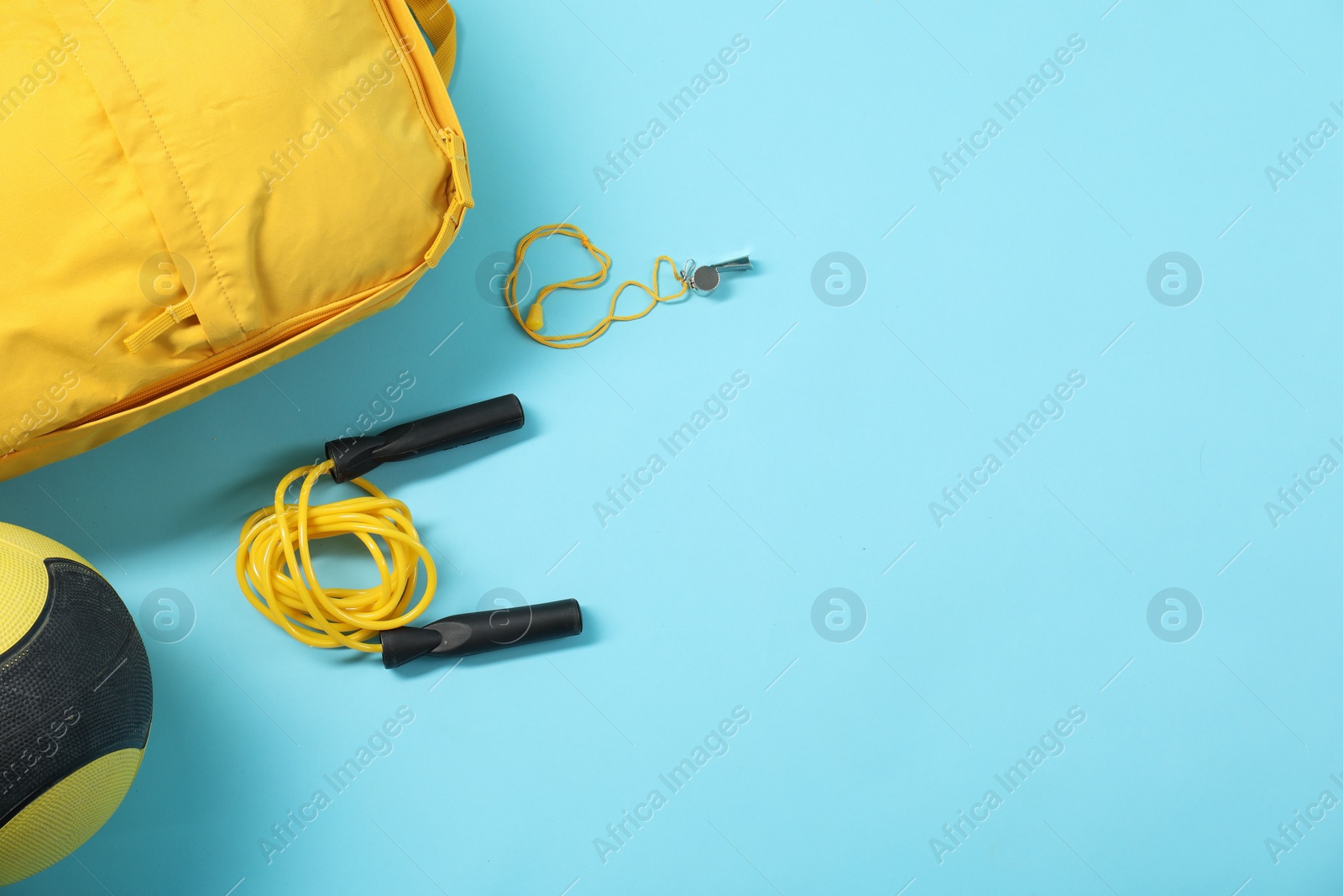 Photo of Different sports equipment on light blue background, flat lay. Space for text