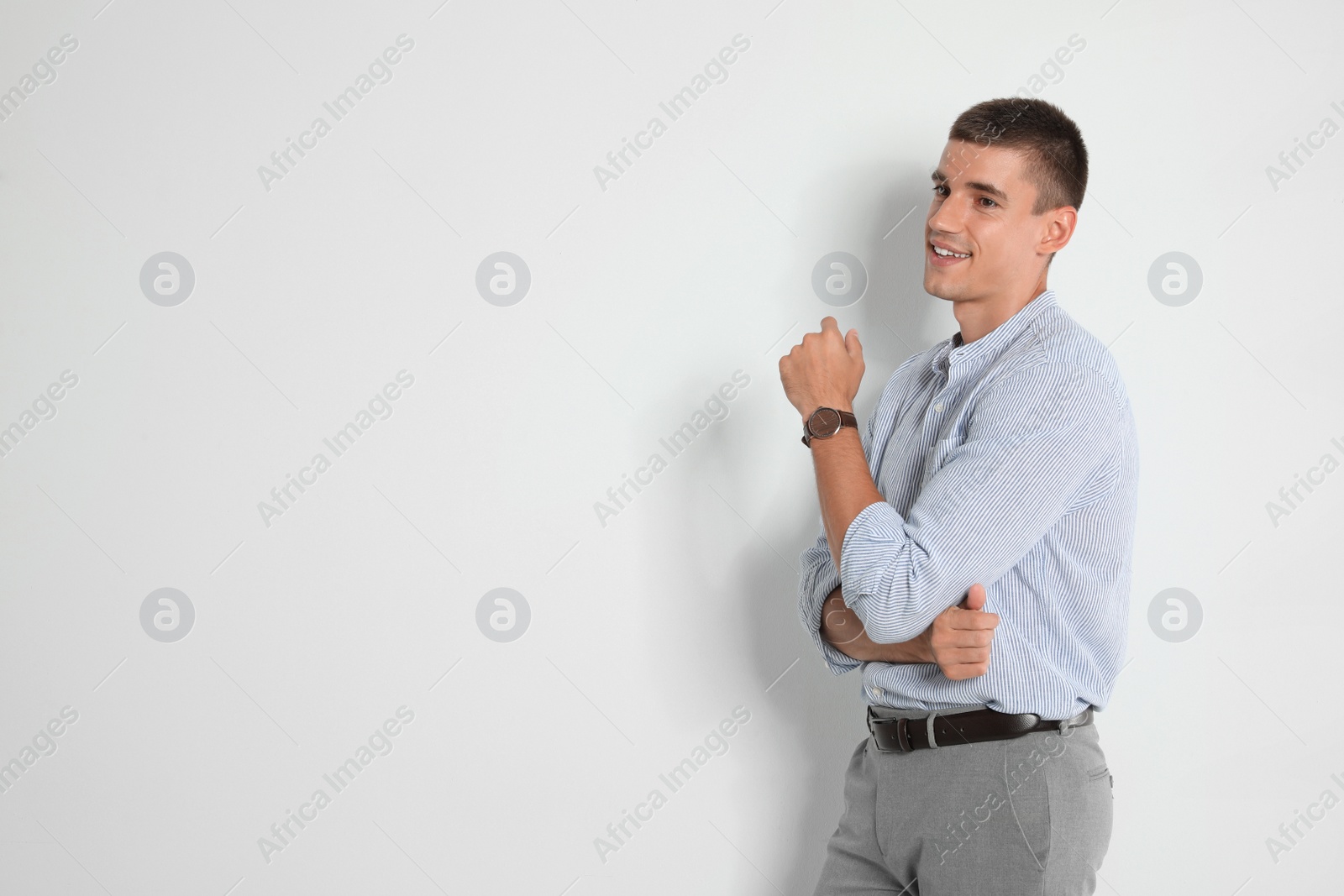 Photo of Portrait of handsome young man on light background. Space for text