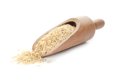 Wooden scoop with brown rice on white background