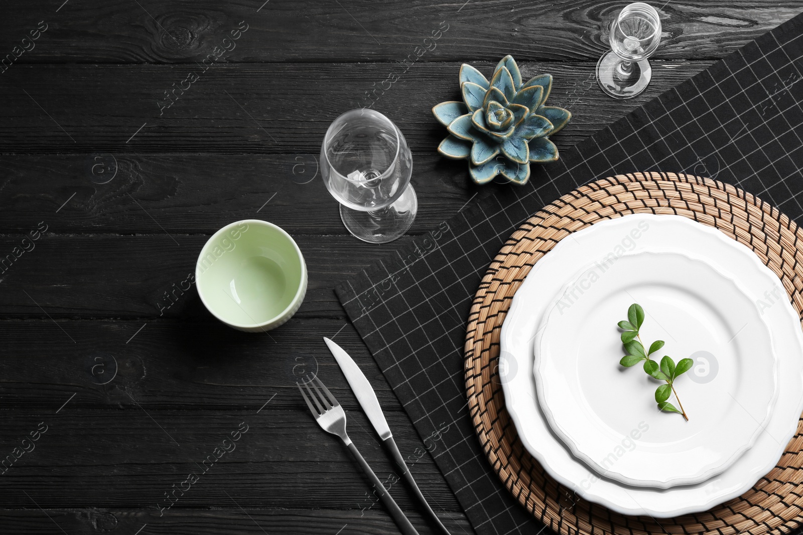 Photo of Elegant table setting on black wooden background, flat lay