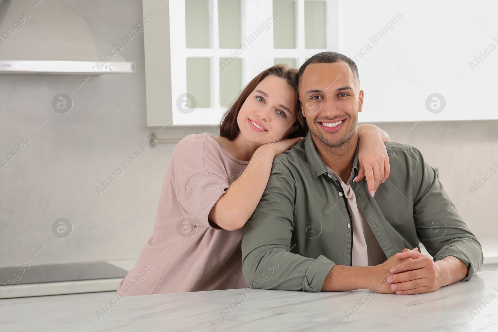 Photo of Dating agency. Happy couple spending time together in kitchen, space for text