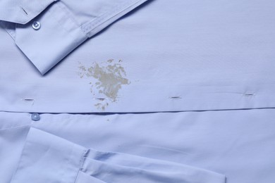 Photo of Closeup view of light blue shirt with stain