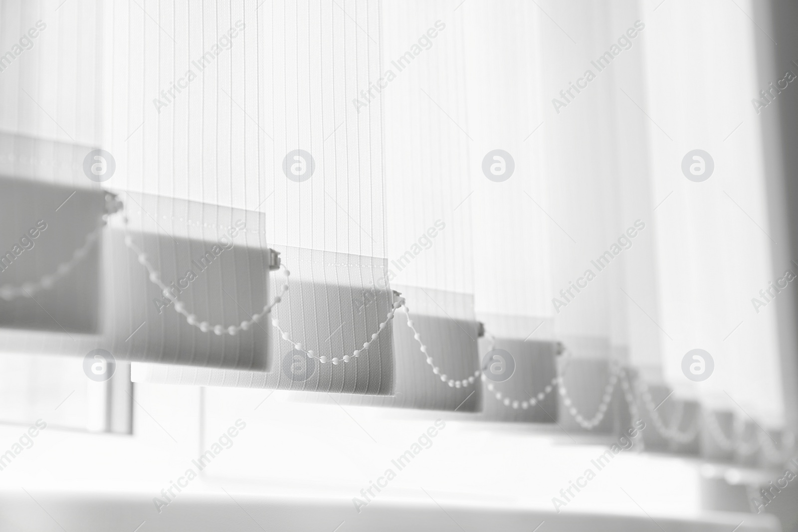 Photo of Closeup view of window with vertical blinds, low angle