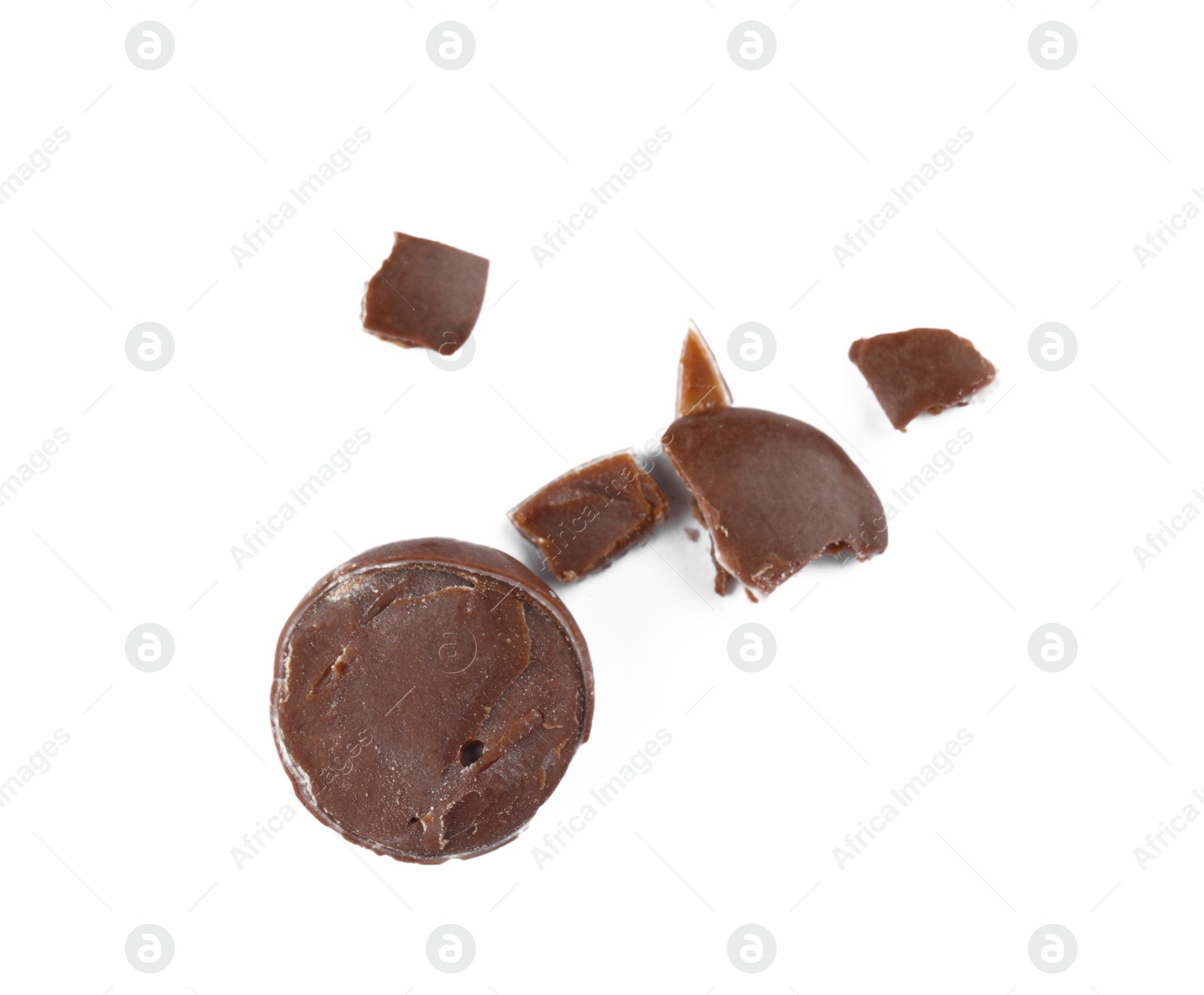 Photo of Crushed chocolate candy on white background, top view