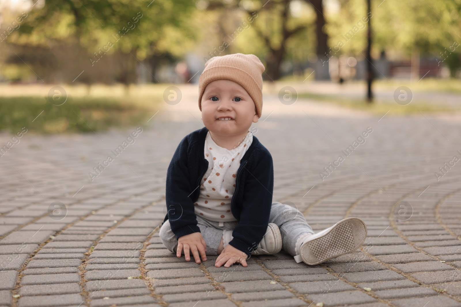 Photo of Portrait of little baby sitting in park