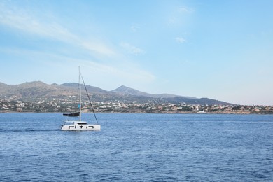 Beautiful view of sea with boat and distant coastal city