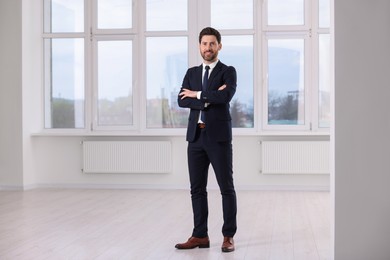 Photo of Happy real estate agent in new apartment