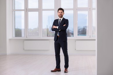 Happy real estate agent in new apartment