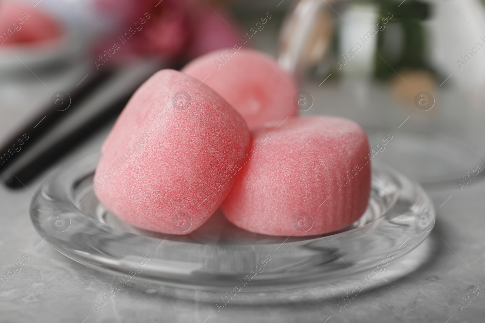 Photo of Glass plate with delicious mochi on grey table, closeup. Traditional Japanese dessert