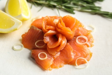 Photo of Fresh sliced salmon fillet with onion, closeup