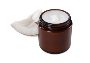 Jar of hand cream and coconut pieces on white background