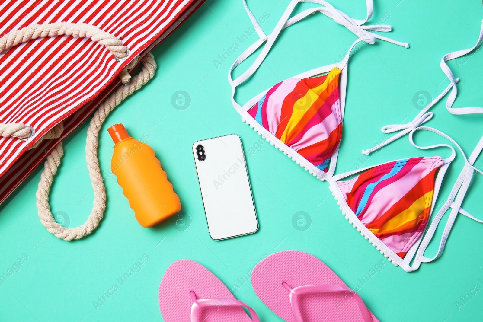 Photo of Flat lay composition with smartphone and beach objects on color background