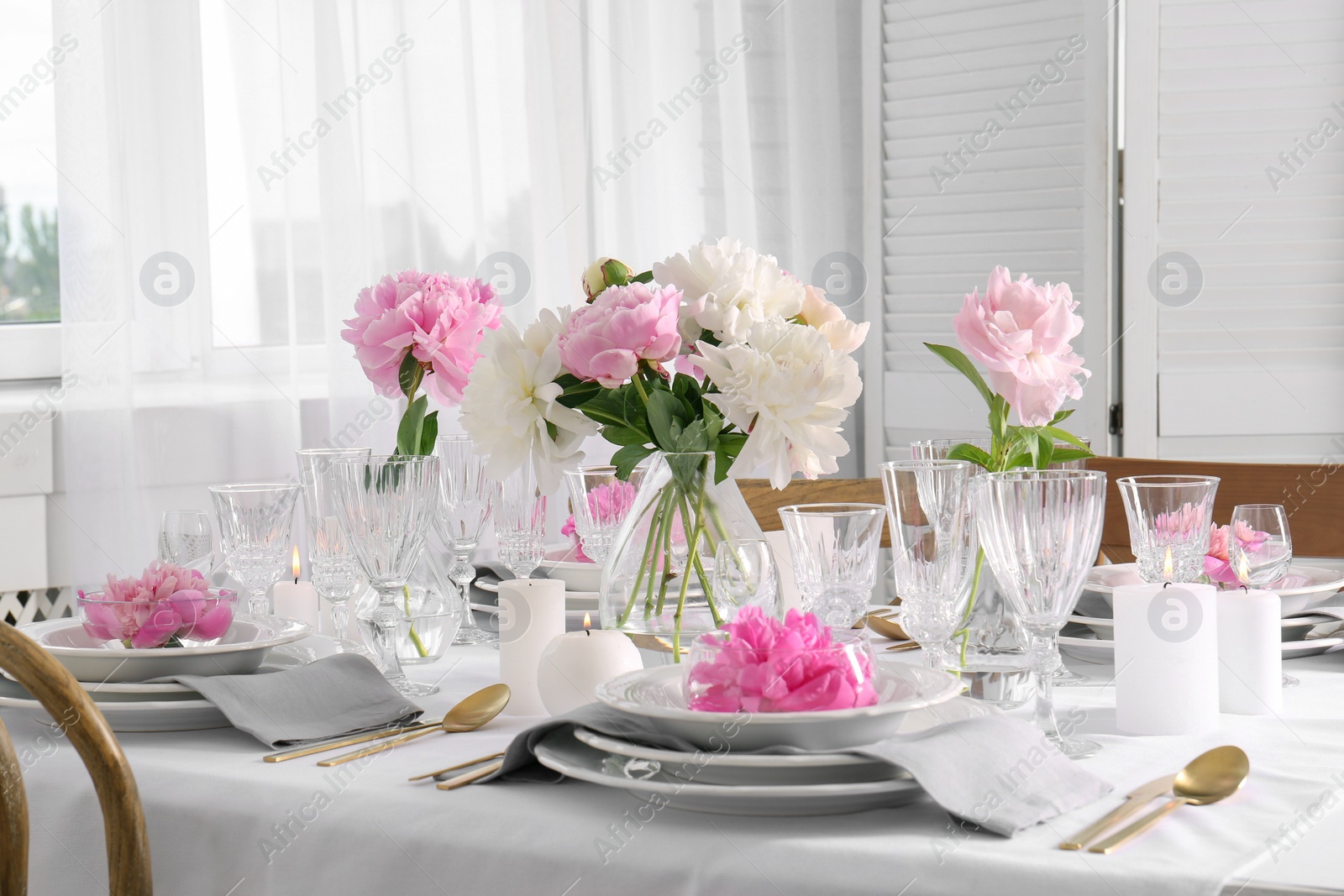 Photo of Stylish table setting with beautiful peonies in dining room