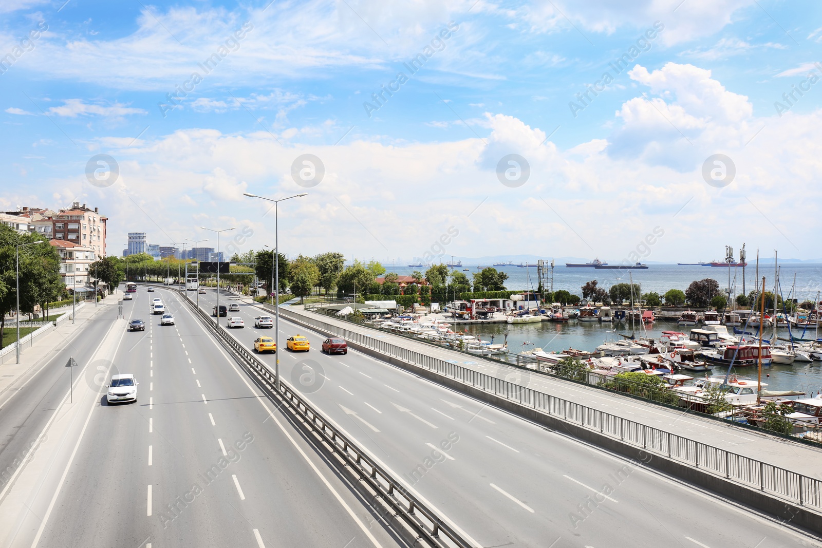 Photo of Beautiful city street with cars near sea