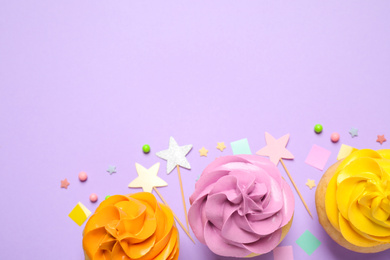 Photo of Colorful birthday cupcakes on lilac background, flat lay. Space for text