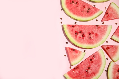 Photo of Watermelon slices on pink background, flat lay. Space for text