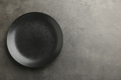Photo of Beautiful ceramic plate on gray table, top view. Space for text