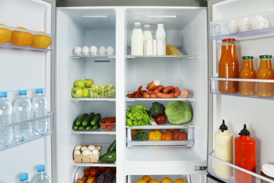 Open refrigerator full of different fresh products