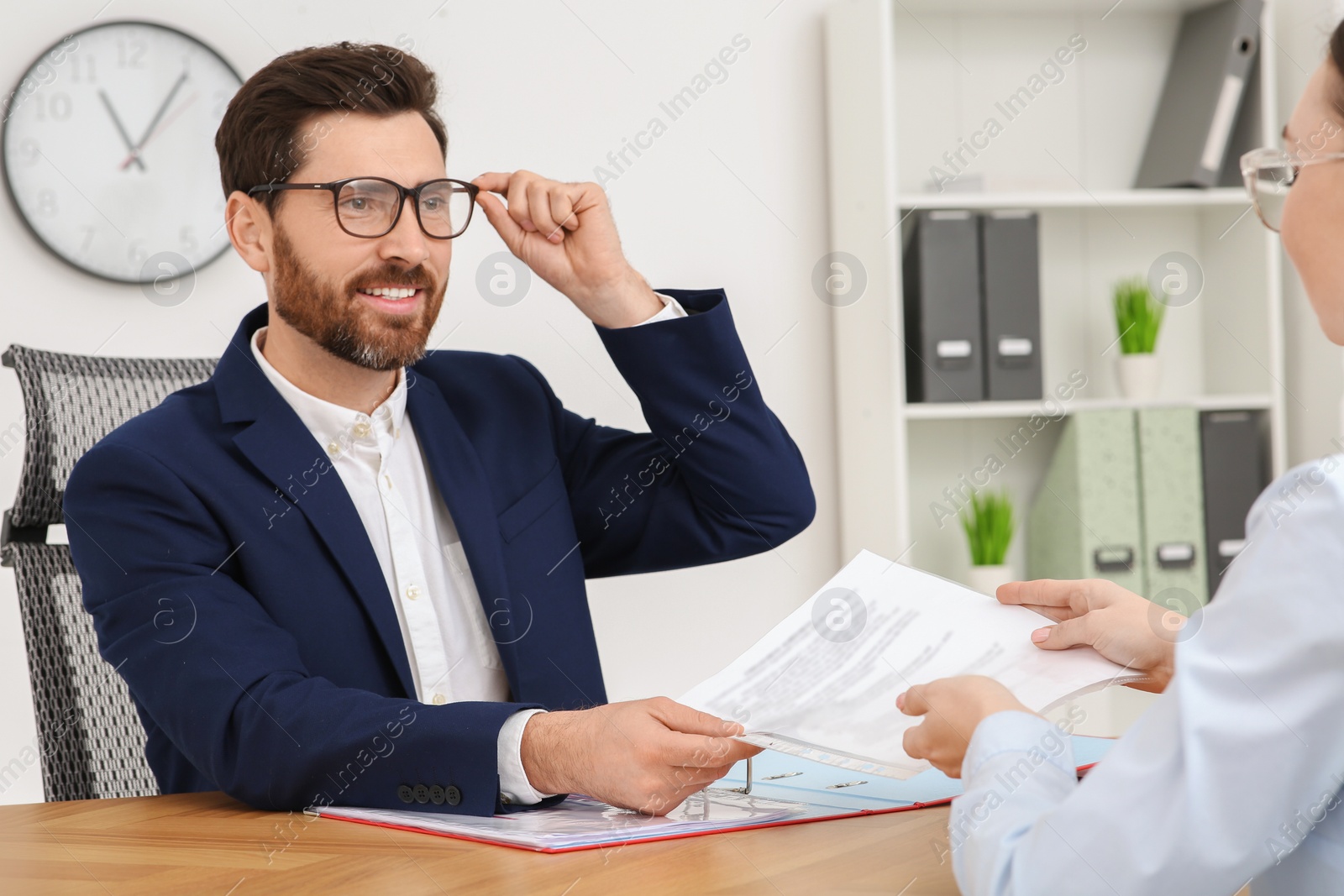 Photo of Businesspeople working with documents at table in office