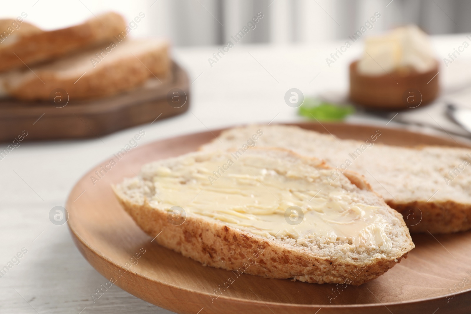 Photo of Fresh bread with tasty butter on plate