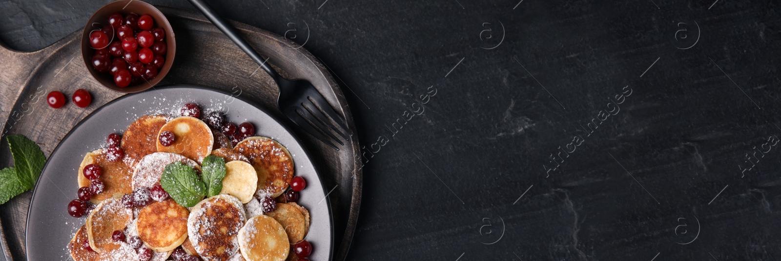 Image of Cereal pancakes with cranberries served on black table, top view with space for text. Banner design