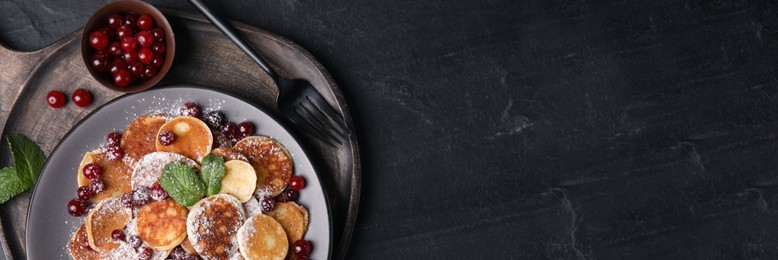 Image of Cereal pancakes with cranberries served on black table, top view with space for text. Banner design