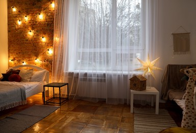 Cozy bedroom with stylish Christmas decor. Interior design