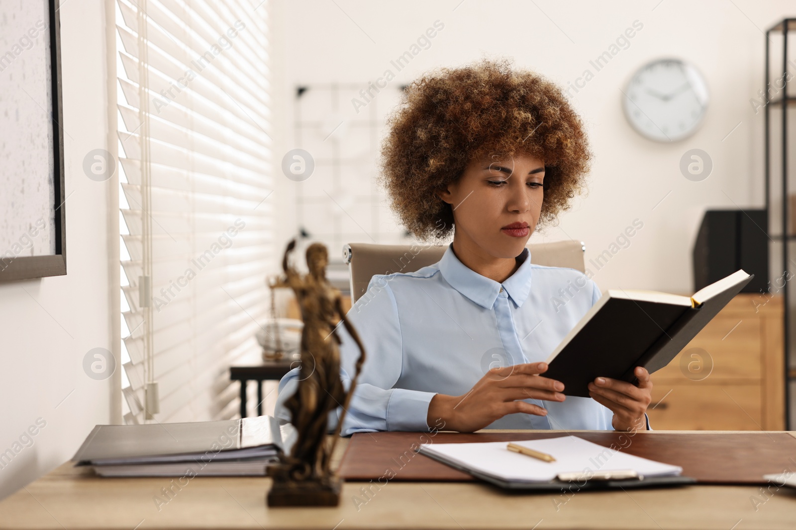 Photo of Notary with notebook at workplace in office