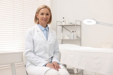 Portrait of happy dermatologist in modern clinic