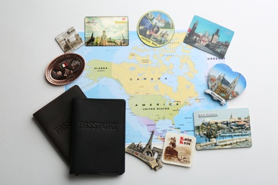 Photo of MYKOLAIV, UKRAINE - DECEMBER 24, 2018: Flat lay composition with map, passports and magnets on light background