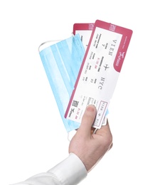 Photo of Man holding tickets and protective mask on white background, closeup. Travel during quarantine