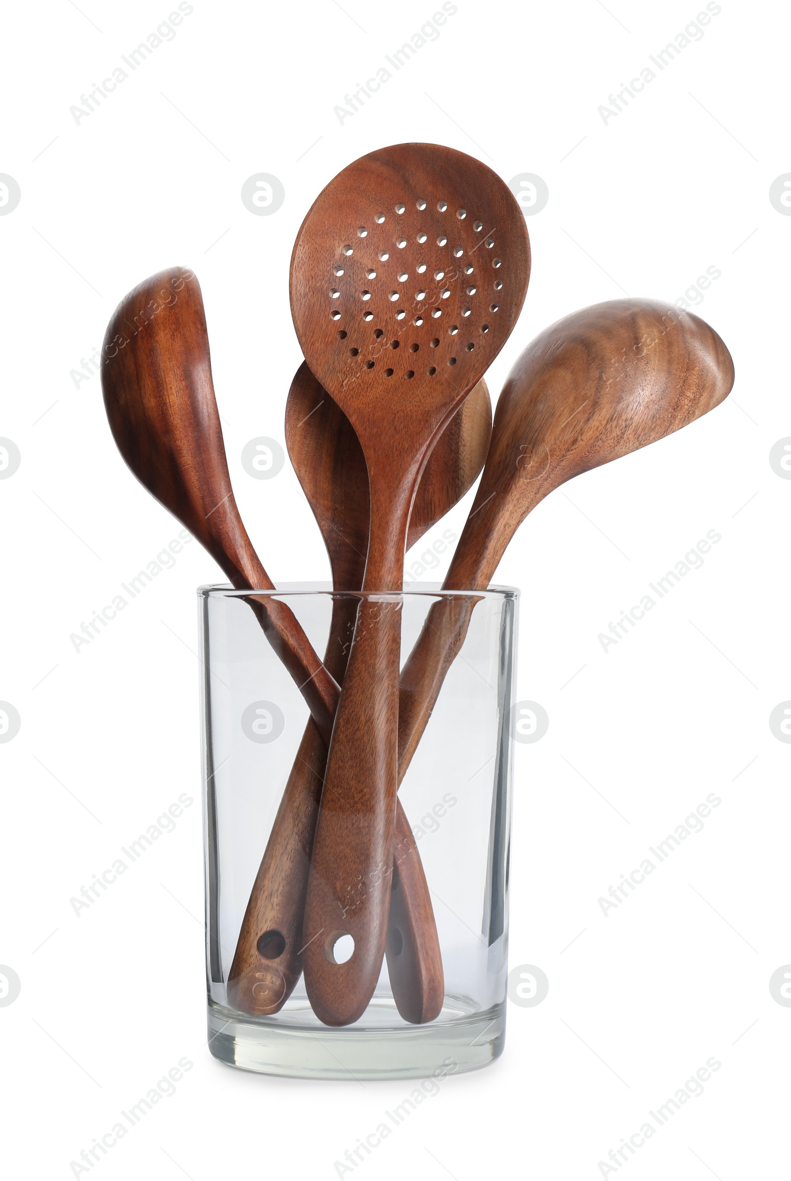 Photo of Set of wooden kitchen utensils in glass holder isolated on white