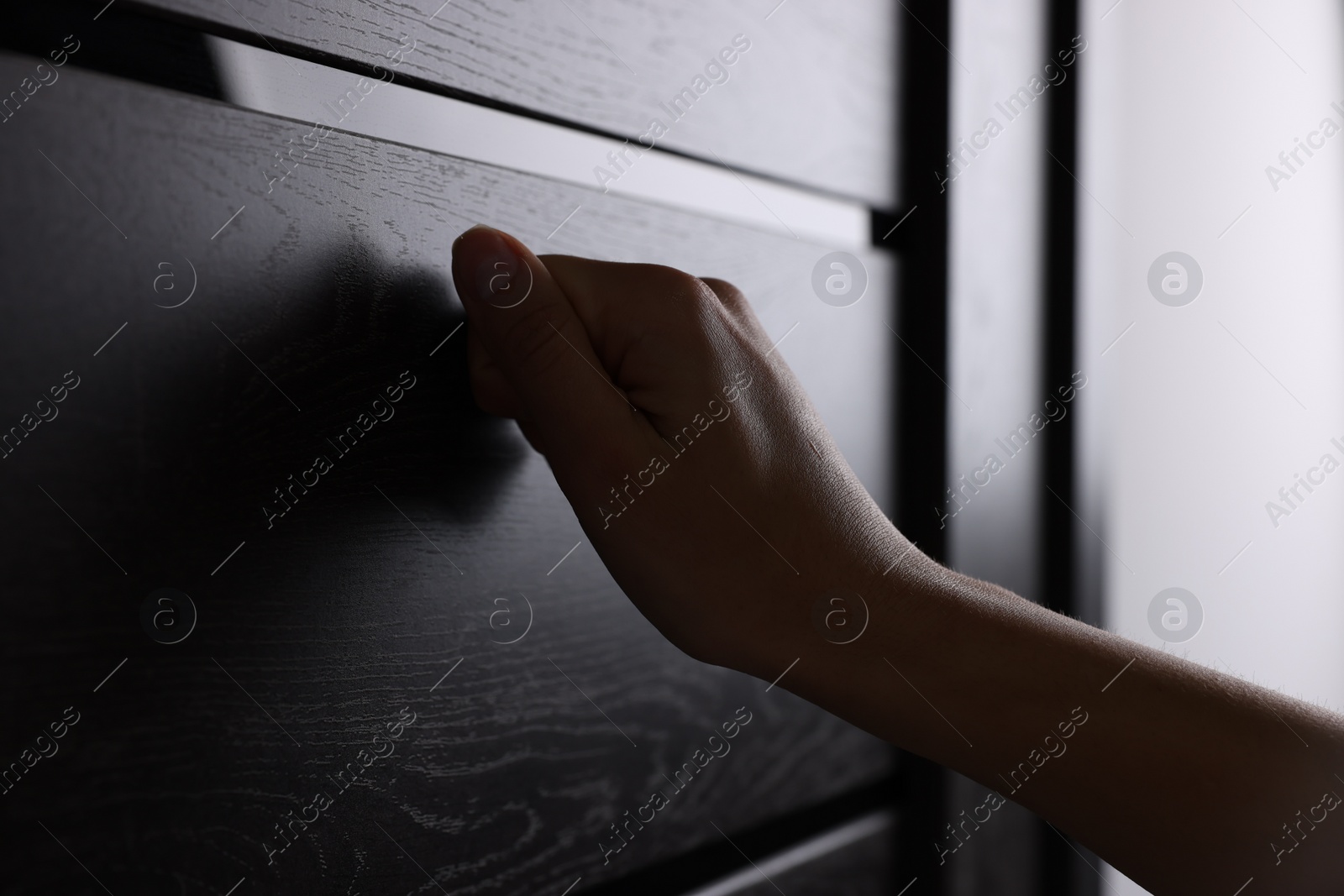 Photo of Woman knocking on door indoors, closeup view