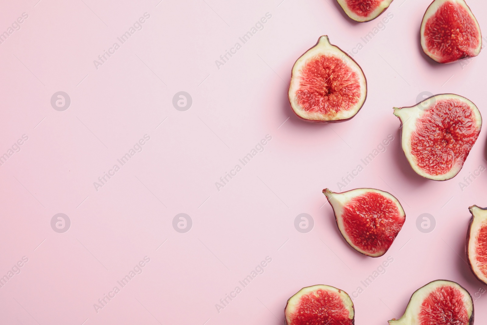 Photo of Delicious ripe figs on pink background, flat lay. Space for text