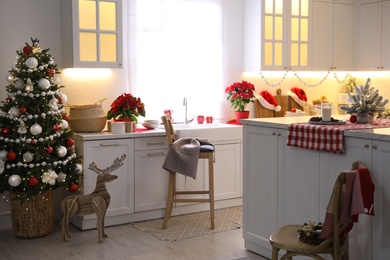 Beautiful kitchen interior with Christmas tree and festive decor