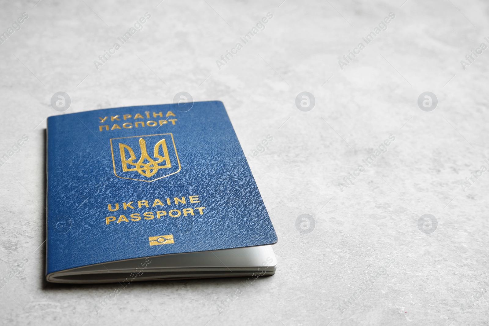 Photo of Ukrainian travel passport on grey background, closeup with space for text. International relationships