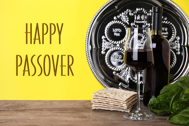 Image of Symbolic Pesach (Passover Seder) items on wooden table against yellow background